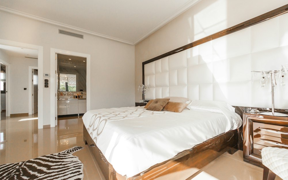 A bedroom with a white bed