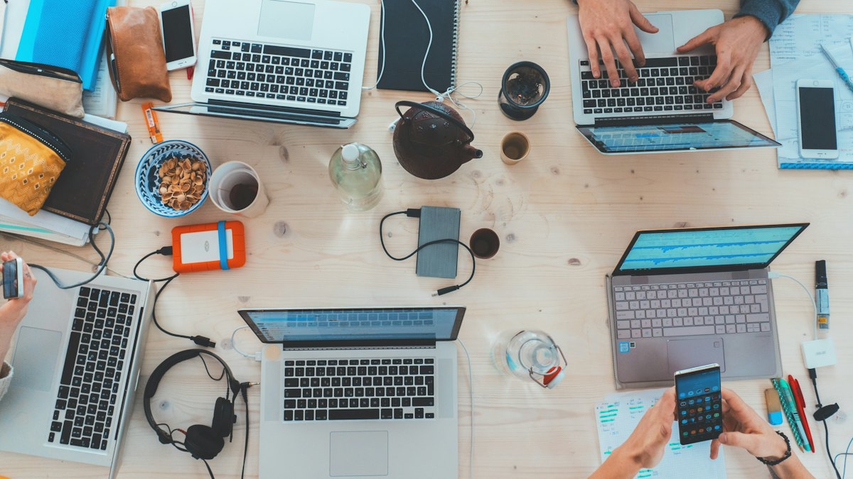 A team working on laptops at a shared desk